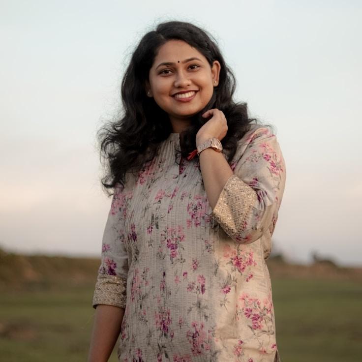 Kaveri Mehta, Lead Design Curator at Atlas Garden Studio, reviewing corporate floral arrangements